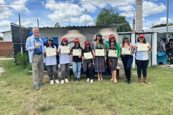 Educators showing their certificates in Balanya