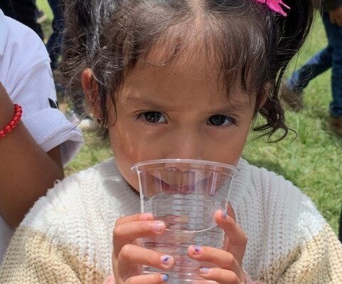 Girl drinking purified water in Balanya