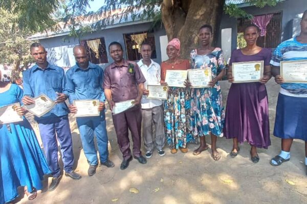 Educators and operators displaying their certificates