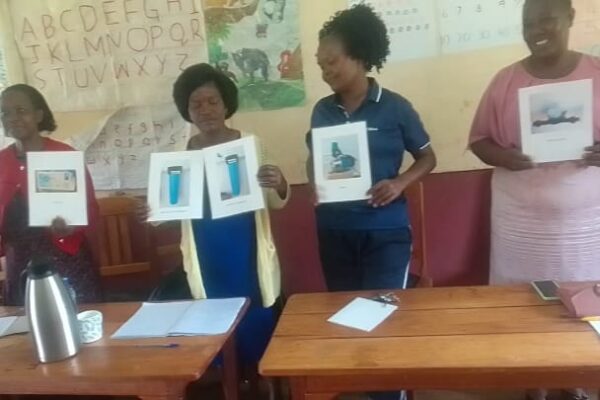 Teachers with instruction on how the water purification system works