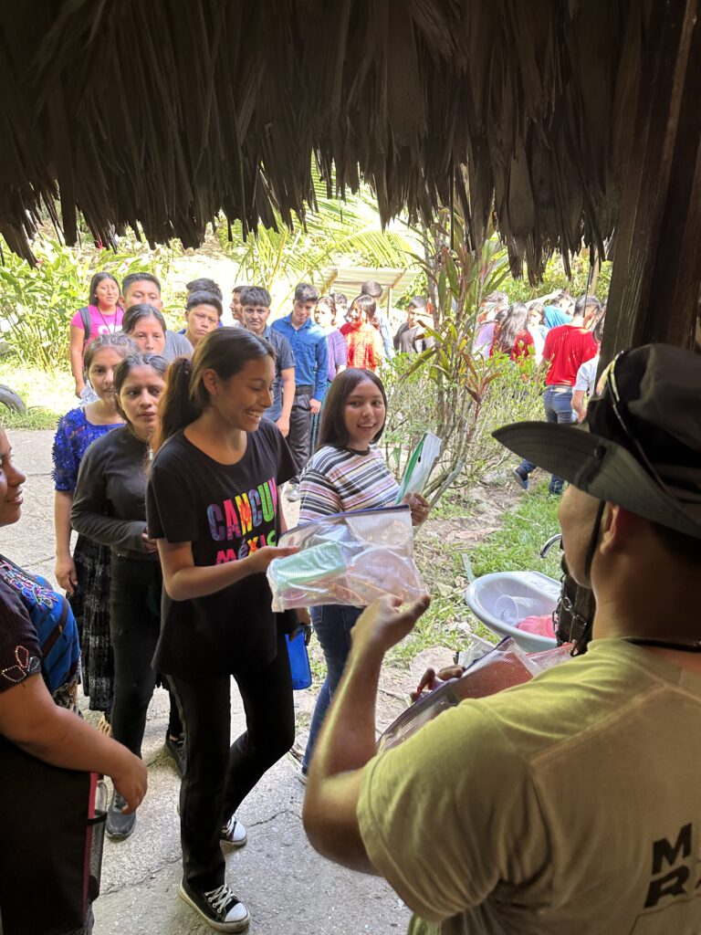 Alejandro handing out health and hygiene gift bags