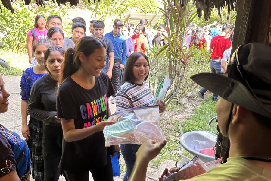 Alejandro handing out health and hygiene gift bags