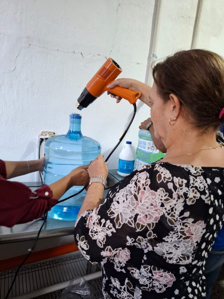 Miriam from CADEP sealing bottles