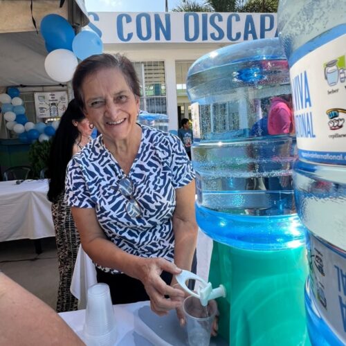 One of CADEPS volunteers serving water at the celebration