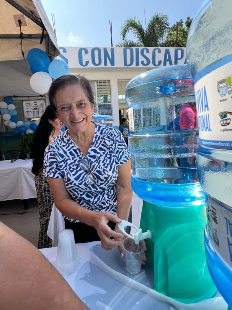 One of CADEPS volunteers serving water at the celebration