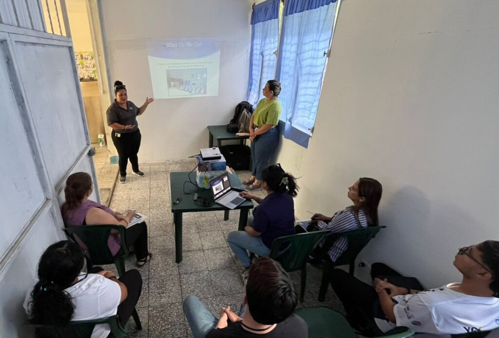 Marisol giving Agua Viva Introduction to the team from CADEP