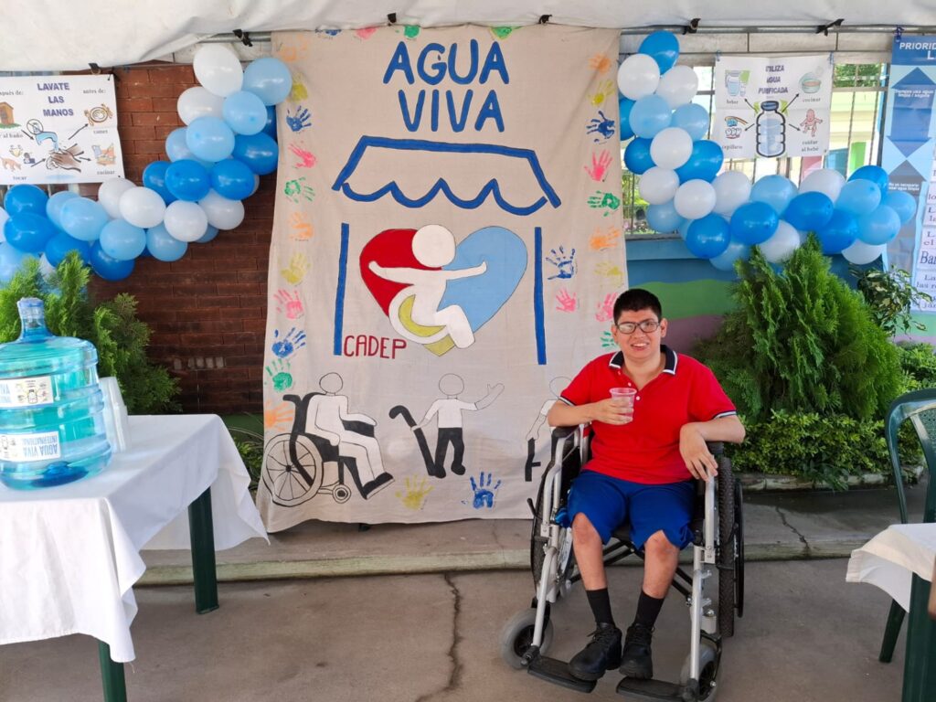 CADEPS banner and one of their patients trying our water