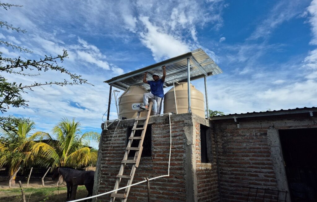 Eluid other than being an Educator is also one of the Operators. Here he is proudly showing the roof the Church built over the tanks to protect them from the direct exposure to the sun