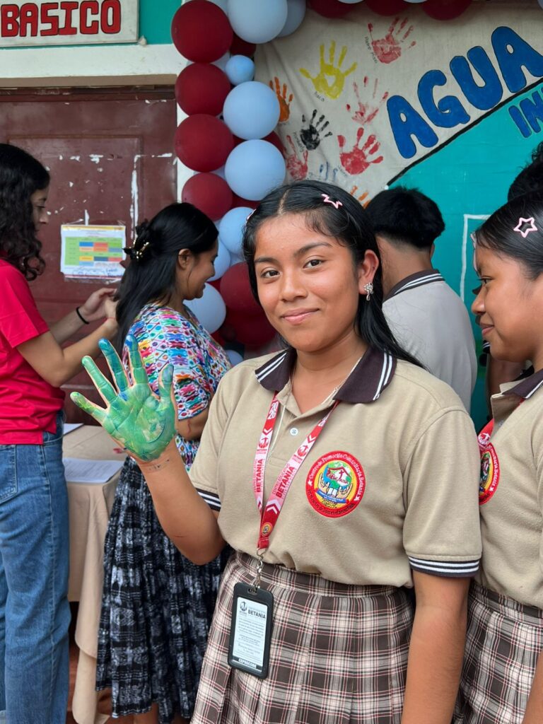 August 28 - A student placing her hand print on the banner